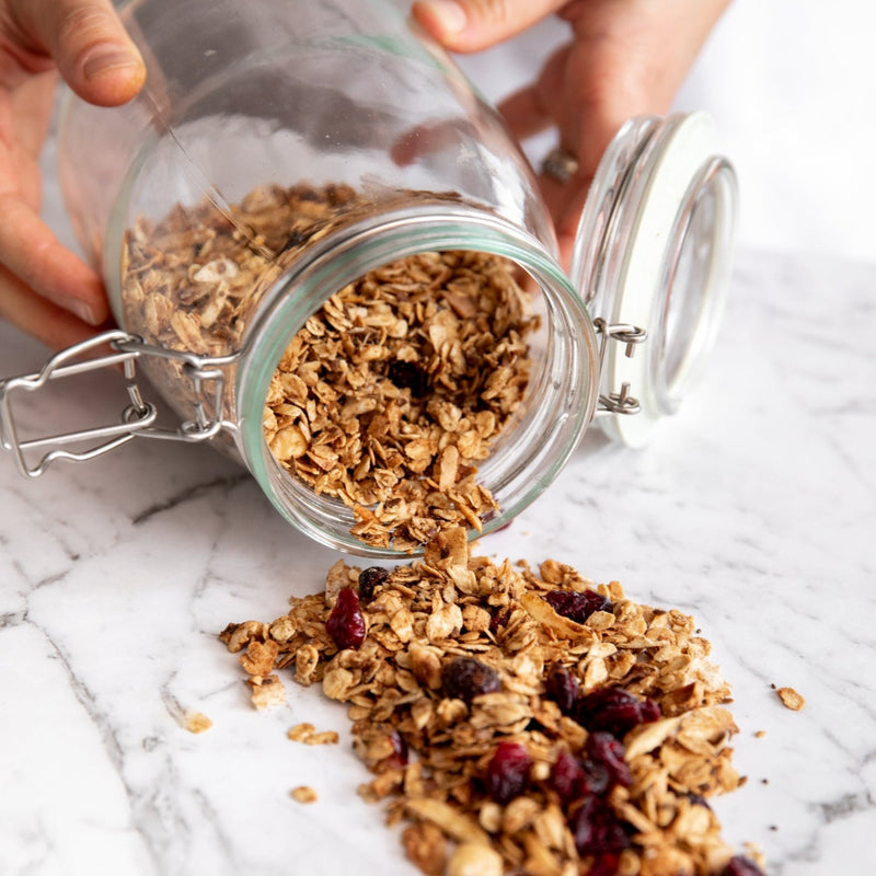healthy organic vegan granola with coconut & cranberries in a brown packet
